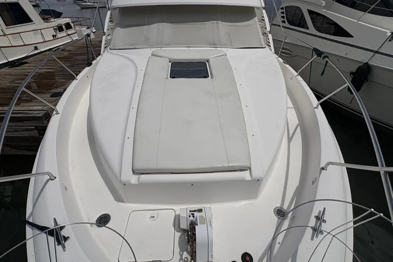 Slide: The Image of 1999 Silverton 392 yacht bow view, docked at marina with surrounding boats. - 37