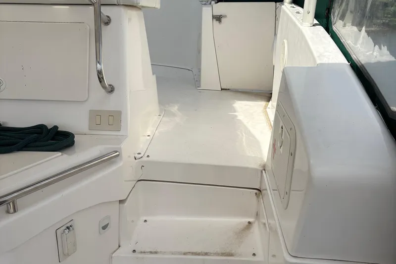 Slide: The Image of 1999 Silverton 392 boat interior with white deck, railing, and storage compartments. - 4