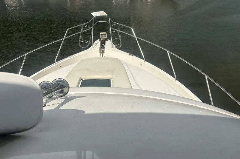Slide: The Image of 1999 Silverton 392 yacht bow view on calm water. - 5