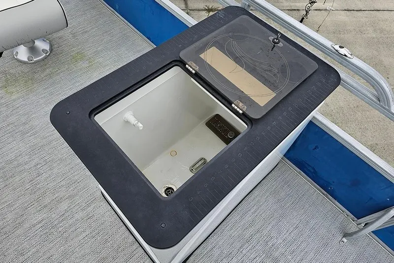 Slide: The Image of 2019 Lexington 321 boat livewell with open lid, showing interior and deck details. - 13