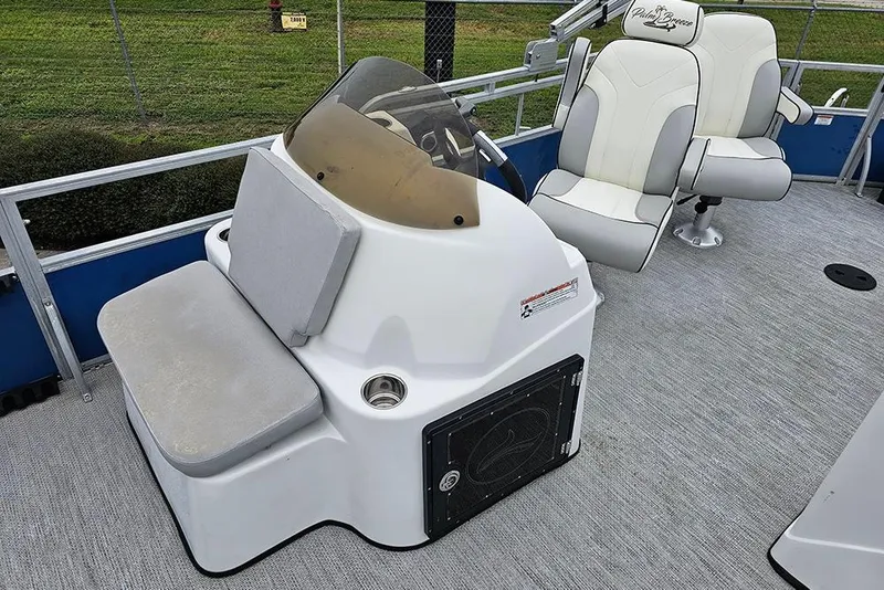 Slide: The Image of 2019 Lexington 321 boat interior with helm and cushioned seating. - 14