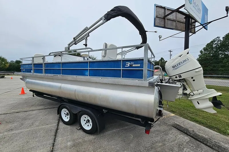 Slide: The Image of 2019 Lexington 321 pontoon boat on trailer with Suzuki outboard motor. - 3