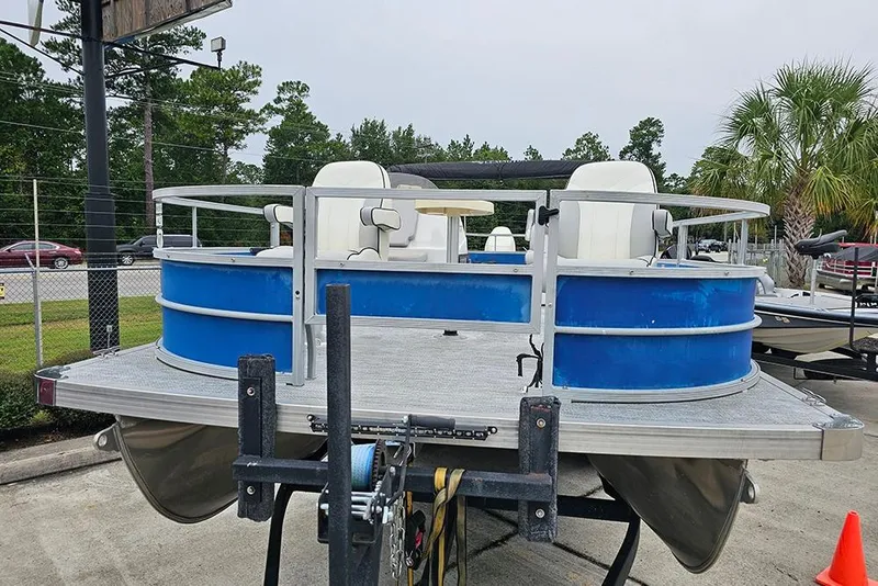 Slide: The Image of 2019 Lexington 321 pontoon boat with blue exterior, parked outdoors. - 4