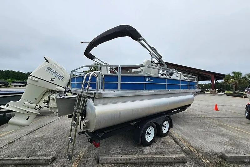Slide: The Image of 2019 Lexington 321 pontoon boat with Suzuki outboard motor on trailer. - 7