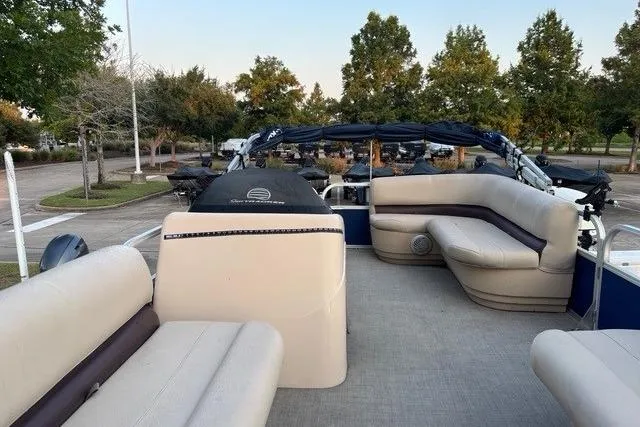 Slide: The Image of 2018 Sun Tracker Party Barge 18 DLX with spacious seating and outdoor setting. - 2