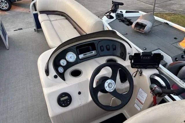 Slide: The Image of 2018 Sun Tracker Party Barge 18 DLX interior with steering console and seating. - 3