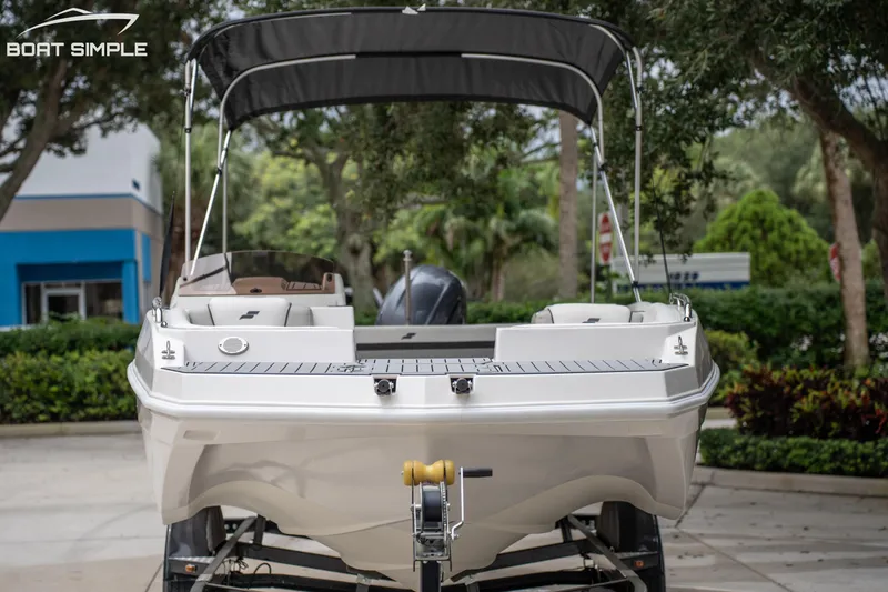 Slide: The Image of 2024 Starcraft SVX 191 OB boat on trailer, featuring sleek design and canopy. - 5