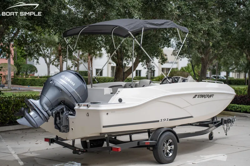 Slide: The Image of 2024 Starcraft SVX 191 OB boat with Yamaha engine on trailer, parked outdoors. - 7