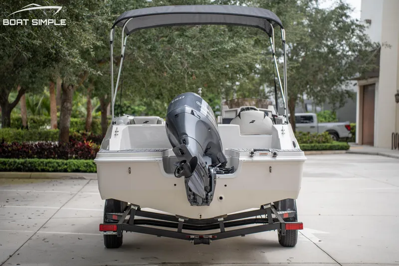 Slide: The Image of 2024 Starcraft SVX 191 OB boat on trailer, rear view with outboard motor. - 9