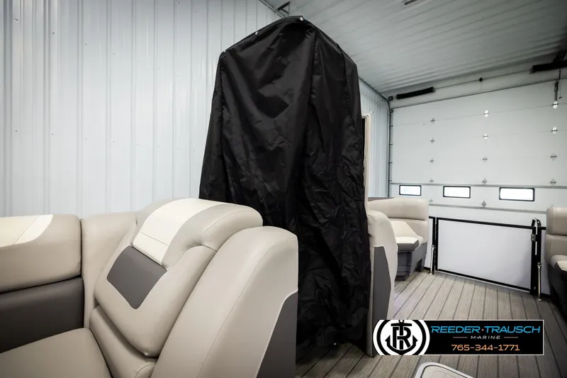 Slide: The Image of 2023 SunChaser 23 Eclipse SSB interior with seating and privacy curtain in a garage. - 22