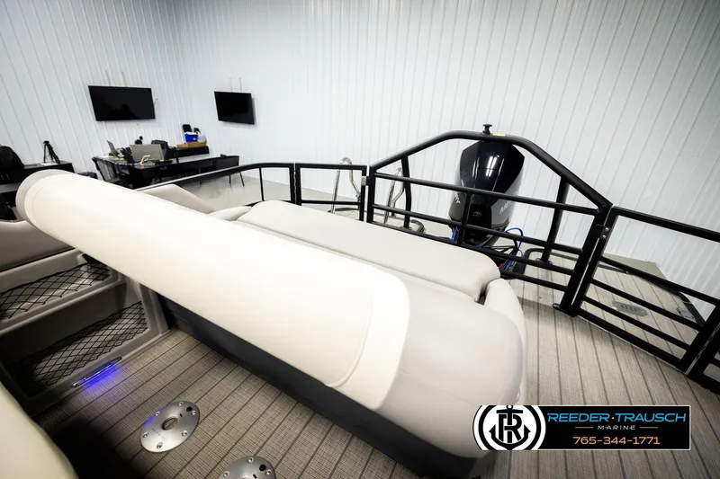 Slide: The Image of 2023 SunChaser 23 Eclipse SSB boat interior with seating and motor in showroom. - 26