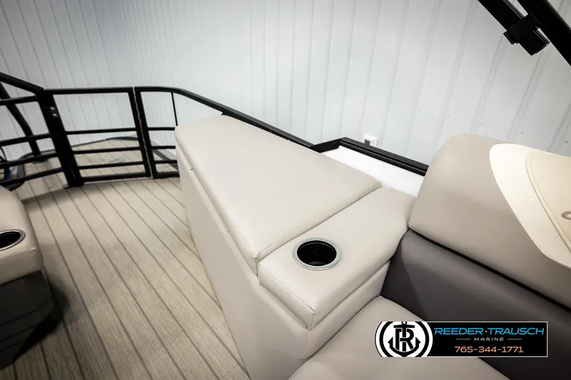 Slide: The Image of 2023 SunChaser 23 Eclipse SSB boat interior with beige seating and cup holder. - 27