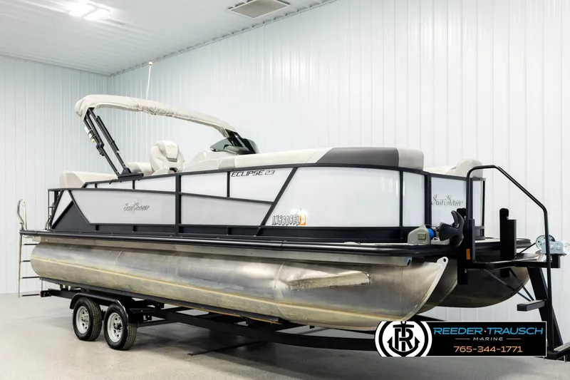 Slide: The Image of 2023 SunChaser 23 Eclipse SSB pontoon boat in a showroom on a trailer. - 3