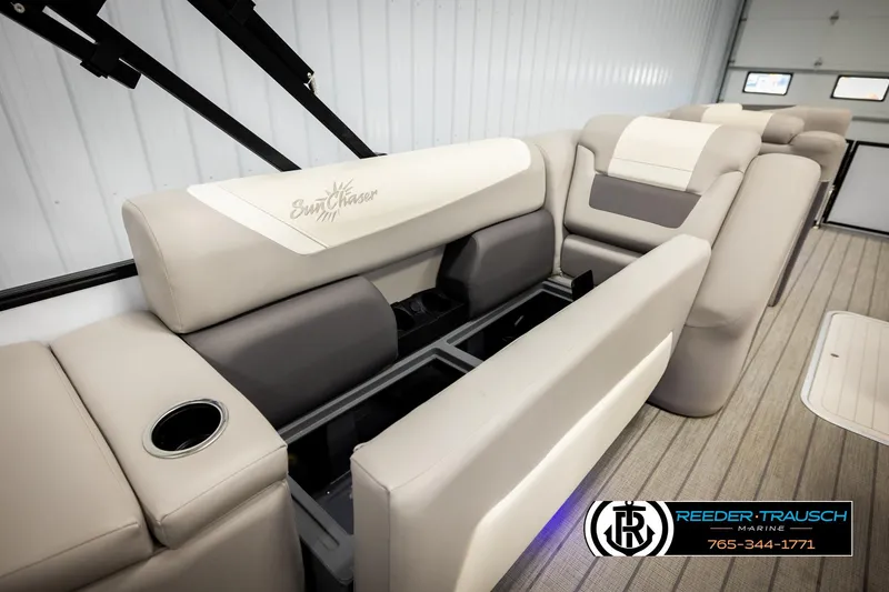 Slide: The Image of 2023 SunChaser 23 Eclipse SSB boat interior with beige seating and storage compartments. - 30