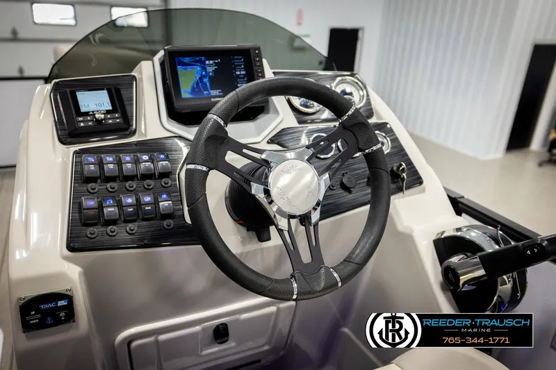 Slide: The Image of 2023 SunChaser 23 Eclipse SSB boat dashboard with steering wheel and control panel. - 32