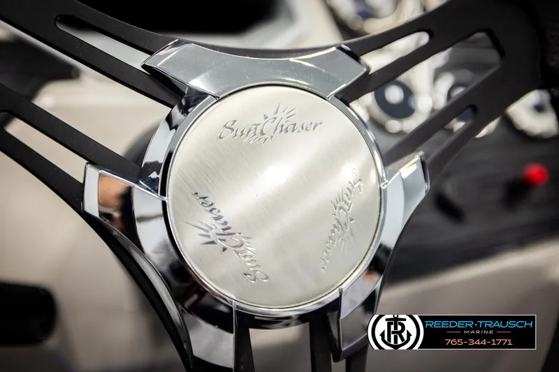 Slide: The Image of Steering wheel of 2023 SunChaser 23 Eclipse SSB boat, featuring sleek design and logo. - 33