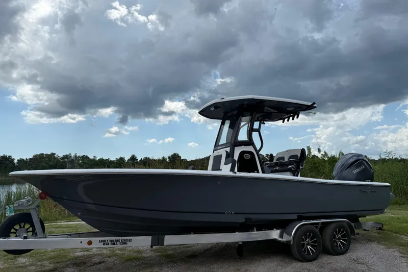 Slide: The Image of 2026 Tidewater 2500 Carolina Bay boat on trailer under cloudy sky. - 10