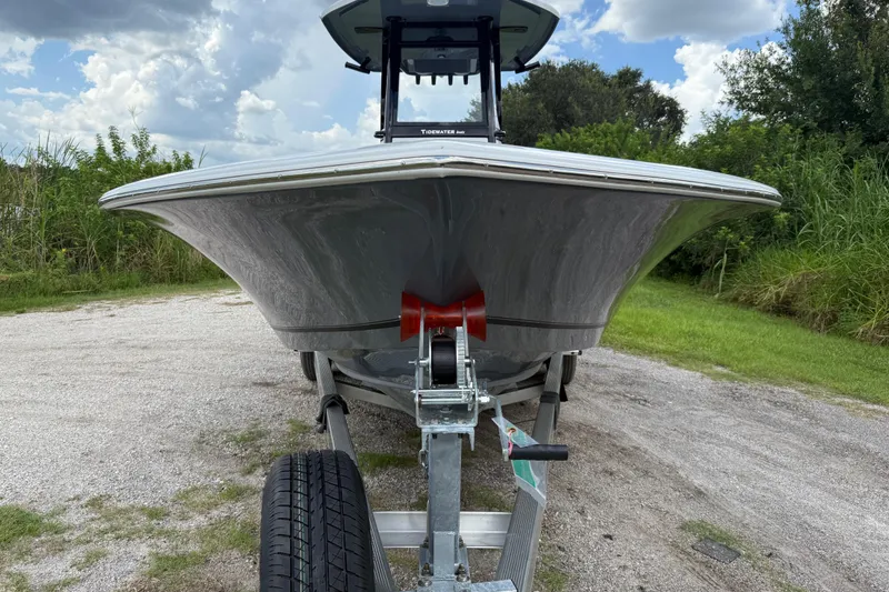 Slide: The Image of 2026 Tidewater 2500 Carolina Bay boat on trailer, parked on gravel path. - 11