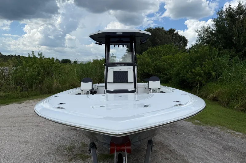 Slide: The Image of 2026 Tidewater 2500 Carolina Bay boat on a gravel path, surrounded by greenery. - 12