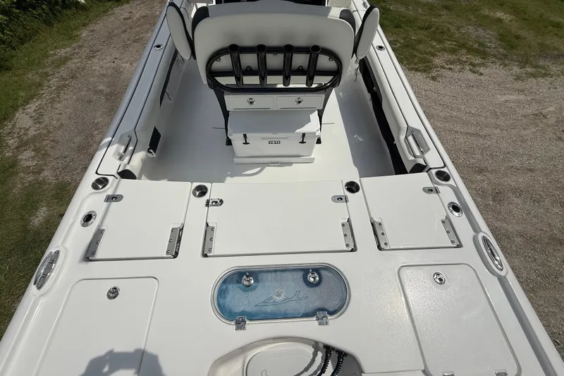 Slide: The Image of 2026 Tidewater 2500 Carolina Bay boat interior with seating and storage compartments. - 13
