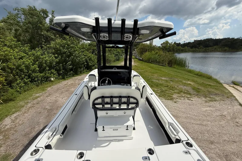 Slide: The Image of 2026 Tidewater 2500 Carolina Bay boat on a scenic lakeside path. - 15