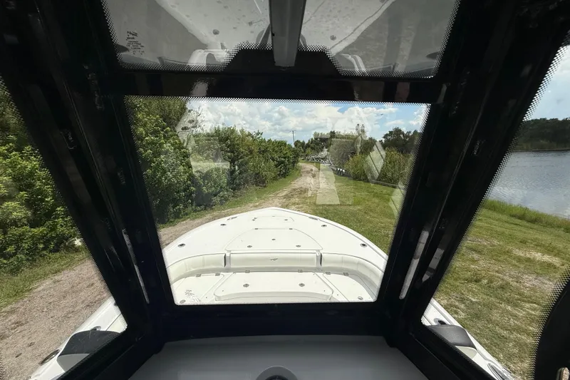 Slide: The Image of View from inside a 2026 Tidewater 2500 Carolina Bay boat, overlooking a scenic path. - 19