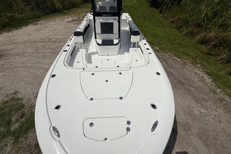 Slide: The Image of 2026 Tidewater 2500 Carolina Bay boat on a gravel path, showcasing sleek design. - 21