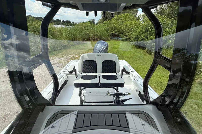 Slide: The Image of 2026 Tidewater 2500 Carolina Bay boat interior with seating, viewed through windshield. - 25