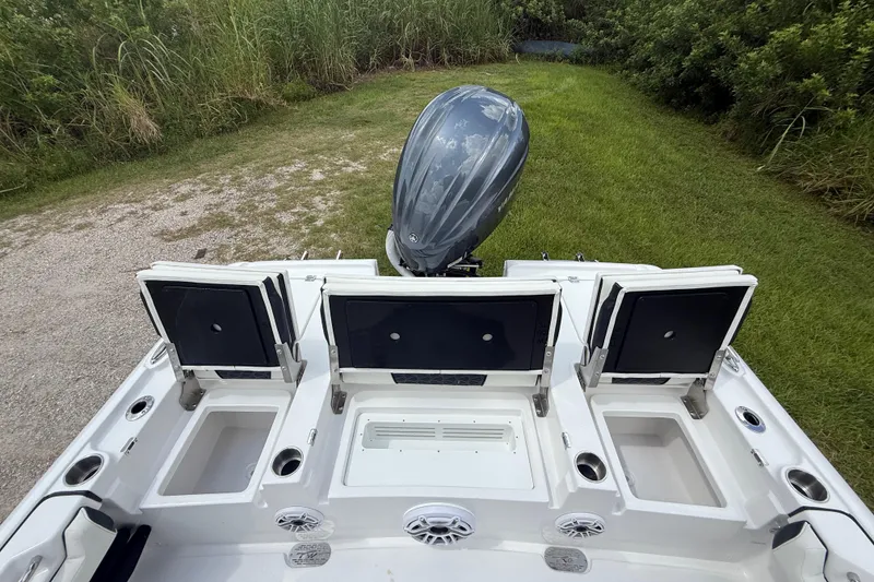 Slide: The Image of 2026 Tidewater 2500 Carolina Bay boat with open storage compartments and outboard motor. - 28