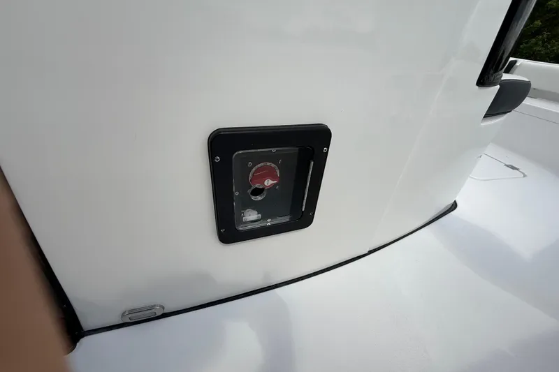 Slide: The Image of 2026 Tidewater 2500 Carolina Bay boat detail with a red valve on the white deck. - 35