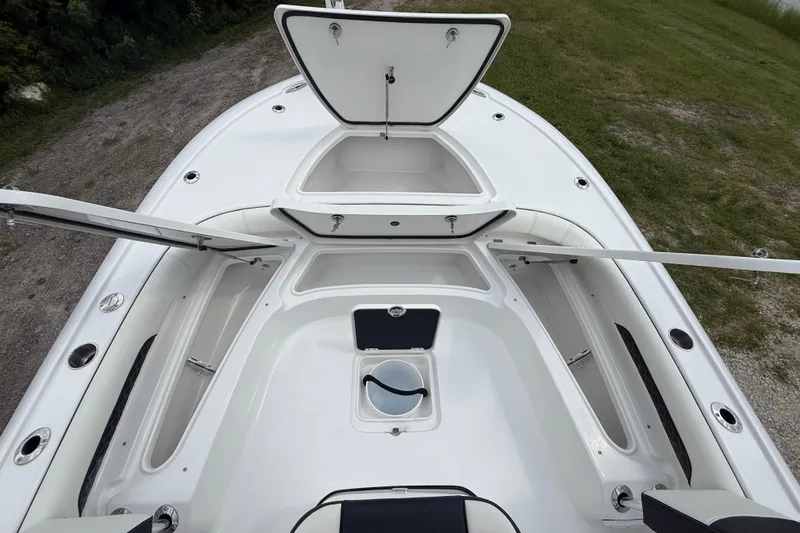 Slide: The Image of 2026 Tidewater 2500 Carolina Bay boat with open storage compartments. - 38