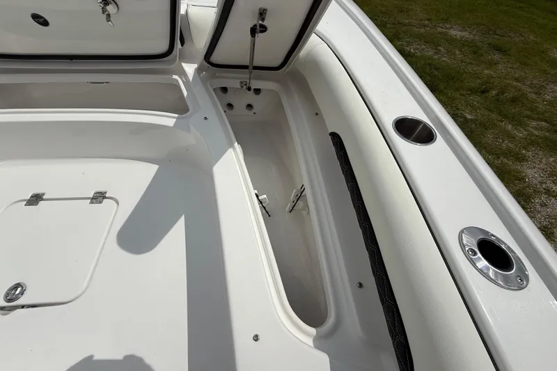 Slide: The Image of 2026 Tidewater 2500 Carolina Bay boat storage compartments and rod holders, open and ready for use. - 41