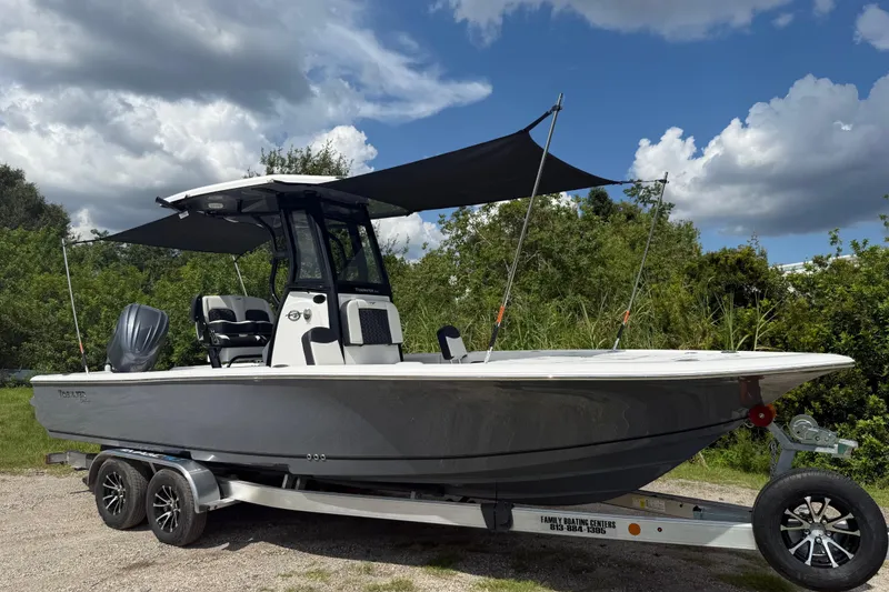 Slide: The Image of 2026 Tidewater 2500 Carolina Bay boat on trailer, parked outdoors under a blue sky. - 46