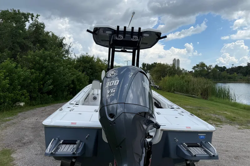 Slide: The Image of 2026 Tidewater 2500 Carolina Bay boat with Yamaha 300 V6 engine, parked near a lake. - 5