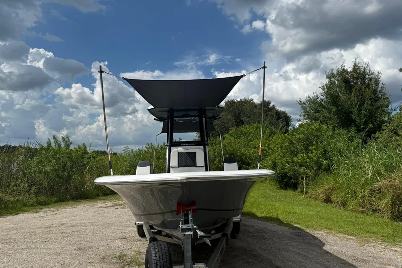 Slide: The Image of 2026 Tidewater 2500 Carolina Bay boat on trailer under cloudy sky. - 50