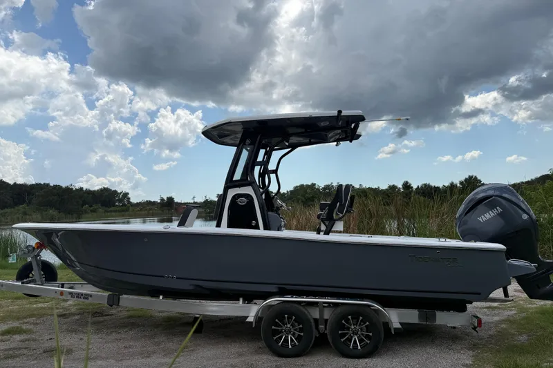Slide: The Image of 2026 Tidewater 2500 Carolina Bay boat on trailer under cloudy sky. - 9