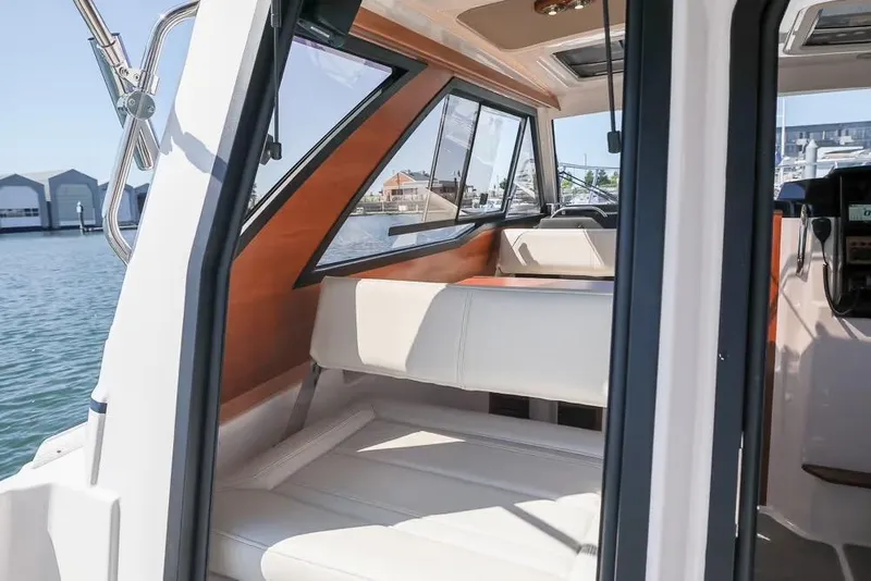 Slide: The Image of 2026 Cutwater C-248 Coupe interior with seating, dockside view. - 10