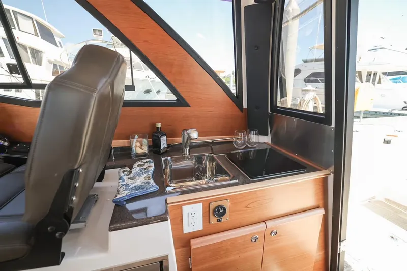 Slide: The Image of Interior of 2026 Cutwater C-248 Coupe featuring a compact kitchenette with sink and counter. - 8