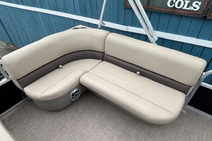 Slide: The Image of 2024 Sun Tracker Party Barge 16 DLX seating with beige upholstery and speaker detail. - 12
