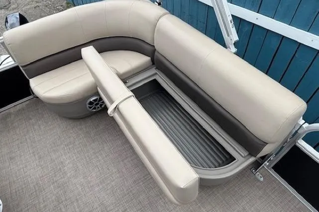 Slide: The Image of 2024 Sun Tracker Party Barge 16 DLX seating with storage compartment open. - 13