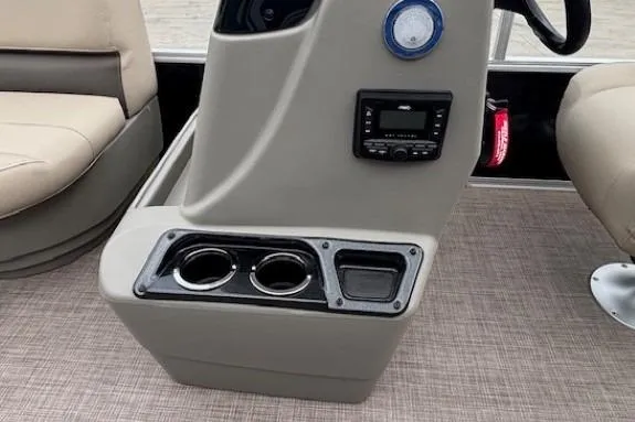 Slide: The Image of 2024 Sun Tracker Party Barge 16 DLX console with cup holders and control panel. - 15