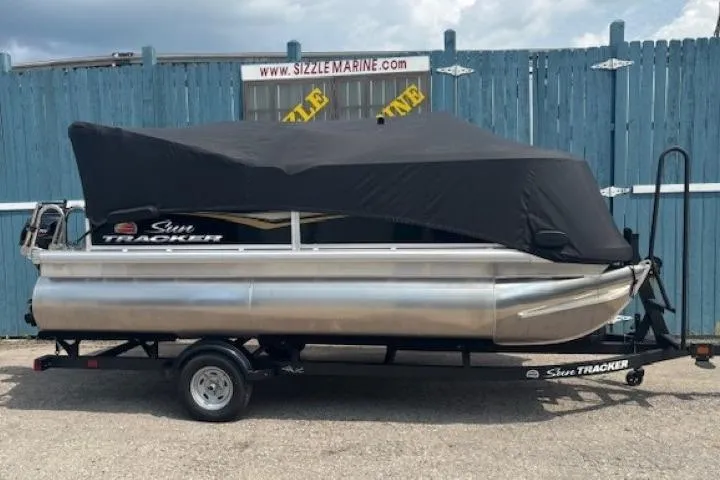 Slide: The Image of 2024 Sun Tracker Party Barge 16 DLX pontoon boat with cover on trailer. - 19