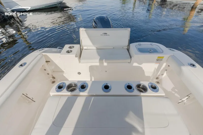 Slide: The Image of 2023 Cobia 220 Center Console boat interior with rod holders and seating. - 7