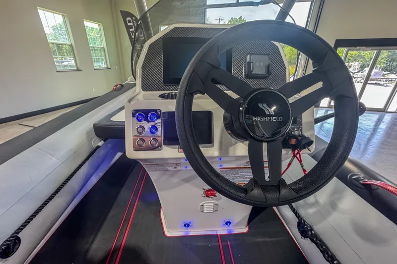 Slide: The Image of 2025 Highfield Velox 420 boat interior with steering wheel and control panel. - 13