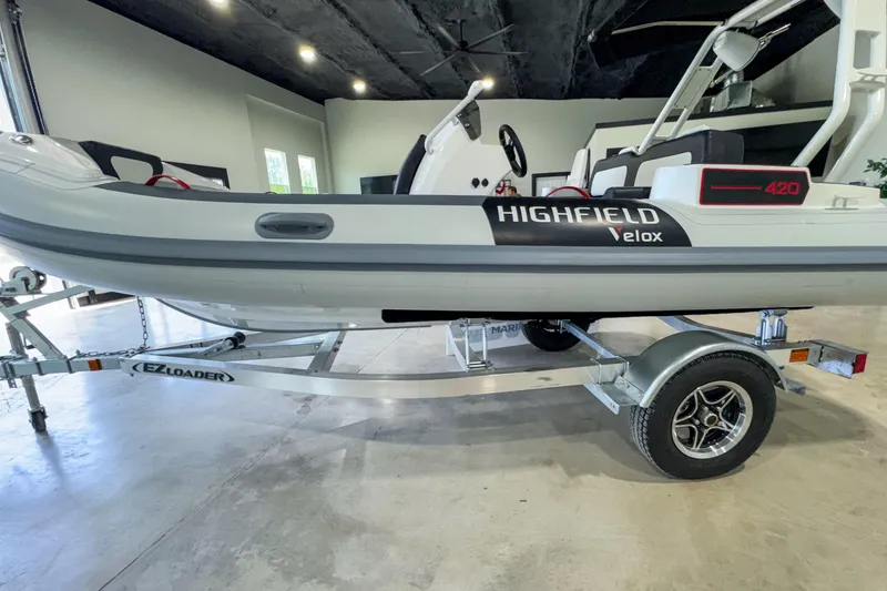Slide: The Image of 2025 Highfield Velox 420 boat on EZ Loader trailer in showroom. - 15