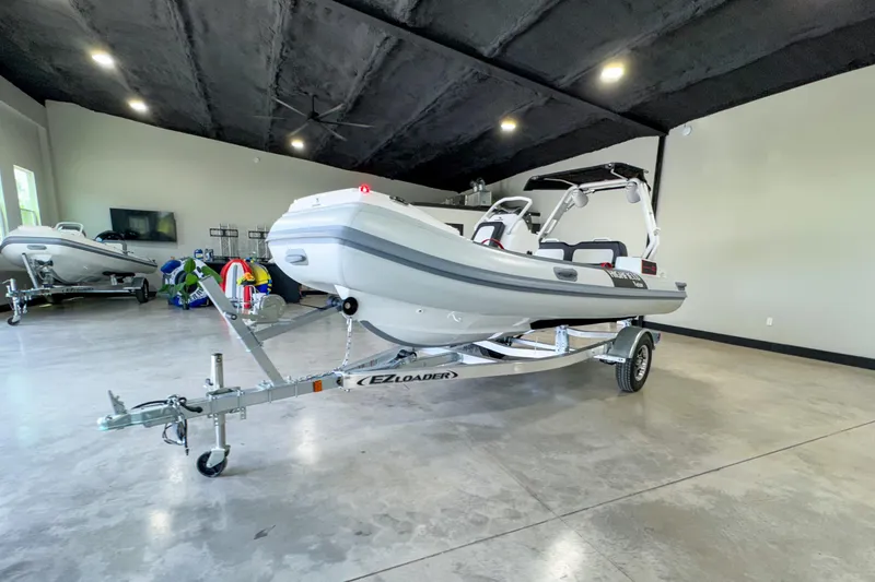 Slide: The Image of 2025 Highfield Velox 420 boat on trailer in showroom. - 16