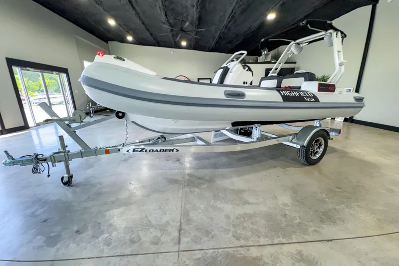 Slide: The Image of 2025 Highfield Velox 420 boat on EZ Loader trailer in showroom. - 17