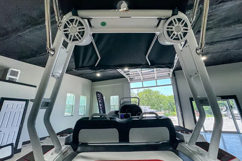 Slide: The Image of 2025 Highfield Velox 420 boat interior with speakers and seating in a showroom. - 20