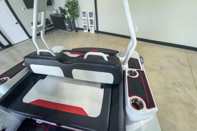 Slide: The Image of 2025 Highfield Velox 420 boat interior with seating and cup holders in showroom. - 6