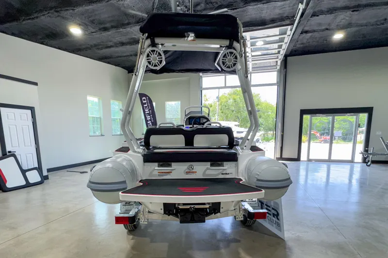 Slide: The Image of 2025 Highfield Velox 420 boat displayed indoors, showcasing rear view and modern design. - 9